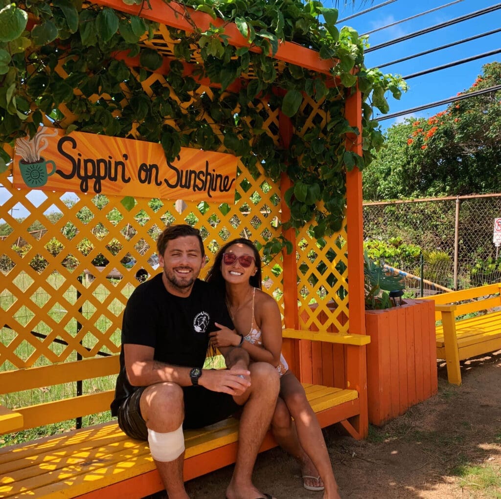 Couple sitting on an orange bench at Sunrise Shack