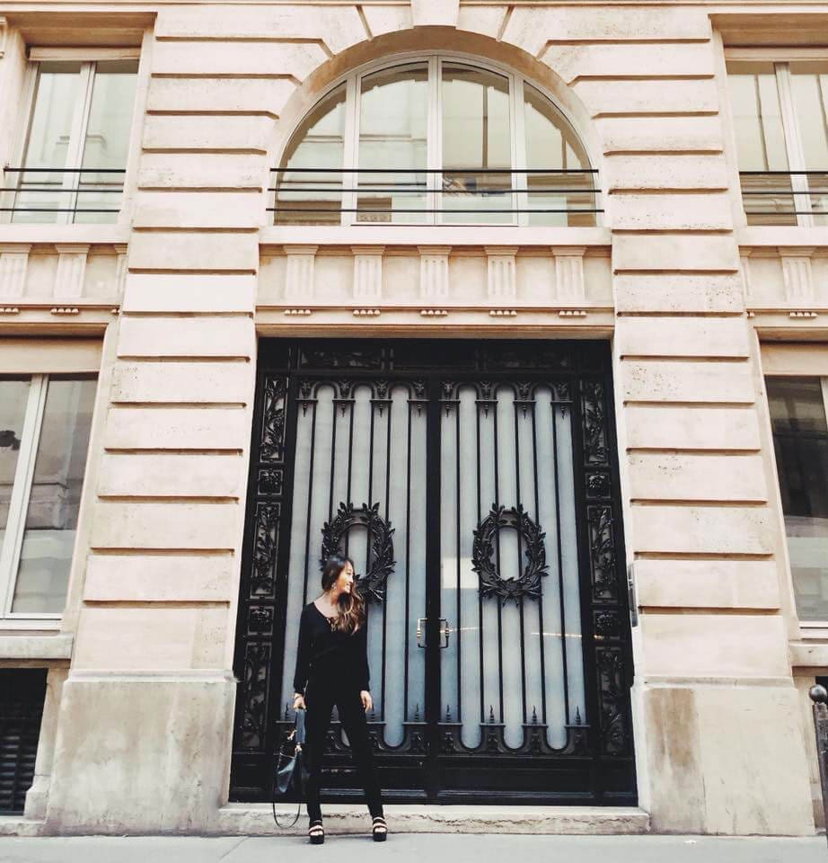 Girl standing in front of a Parisian door