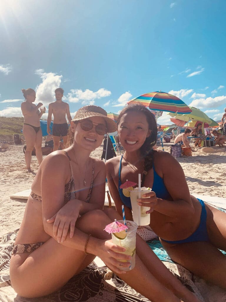 Two girls with capirinhas on the beach
