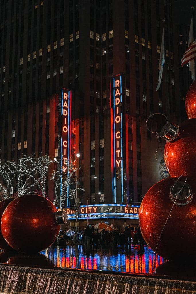 Radio City New York with giant Christmas decorations in foreground