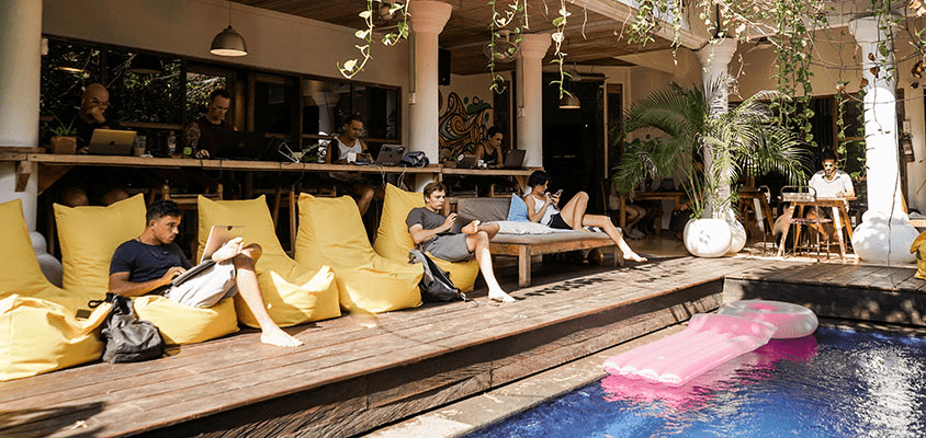 Digital nomads work poolside at Dojo Bali coworking space