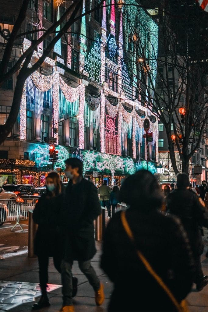 People walk and admire the christmas lights on 5th Avenue New York