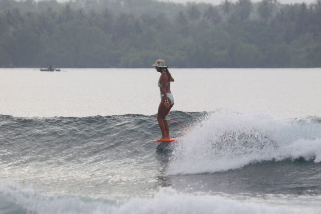 Girl hanging 10 on a longboard