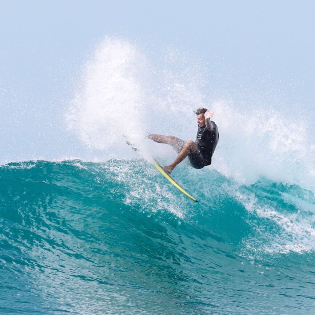 Man surfing with a lot of ocean spray