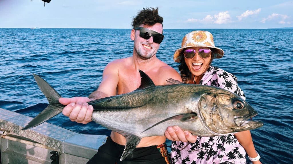 Couple smiling at the camera with a big fish