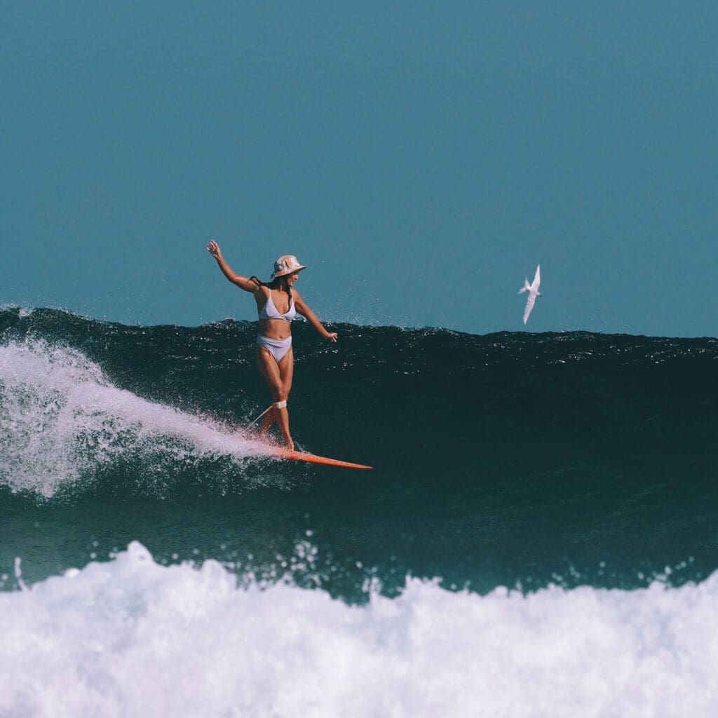 Girl surfing T Land in Rote Island Indonesia