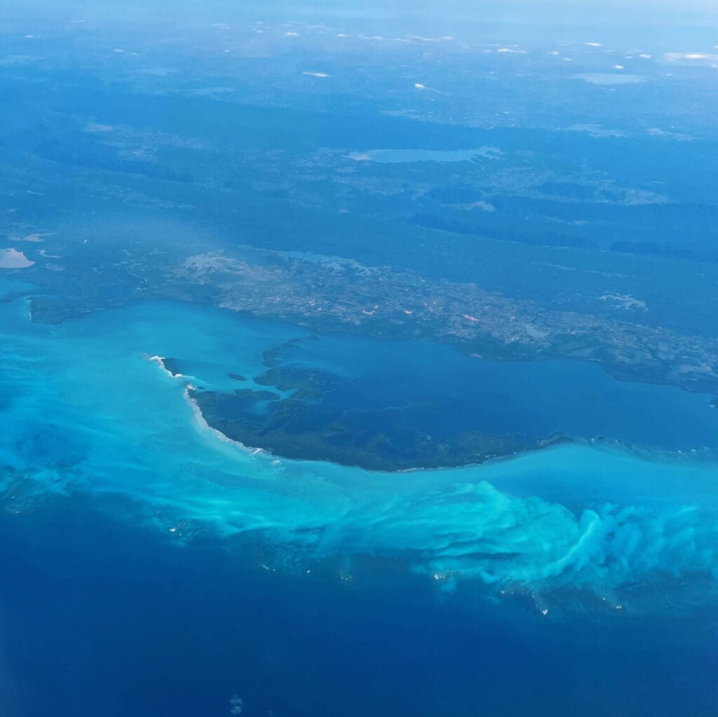 Blue waters outside airplane window