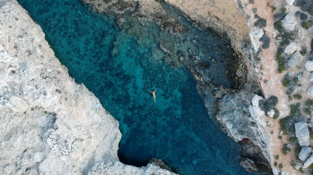 Drone shot of girl floating in water