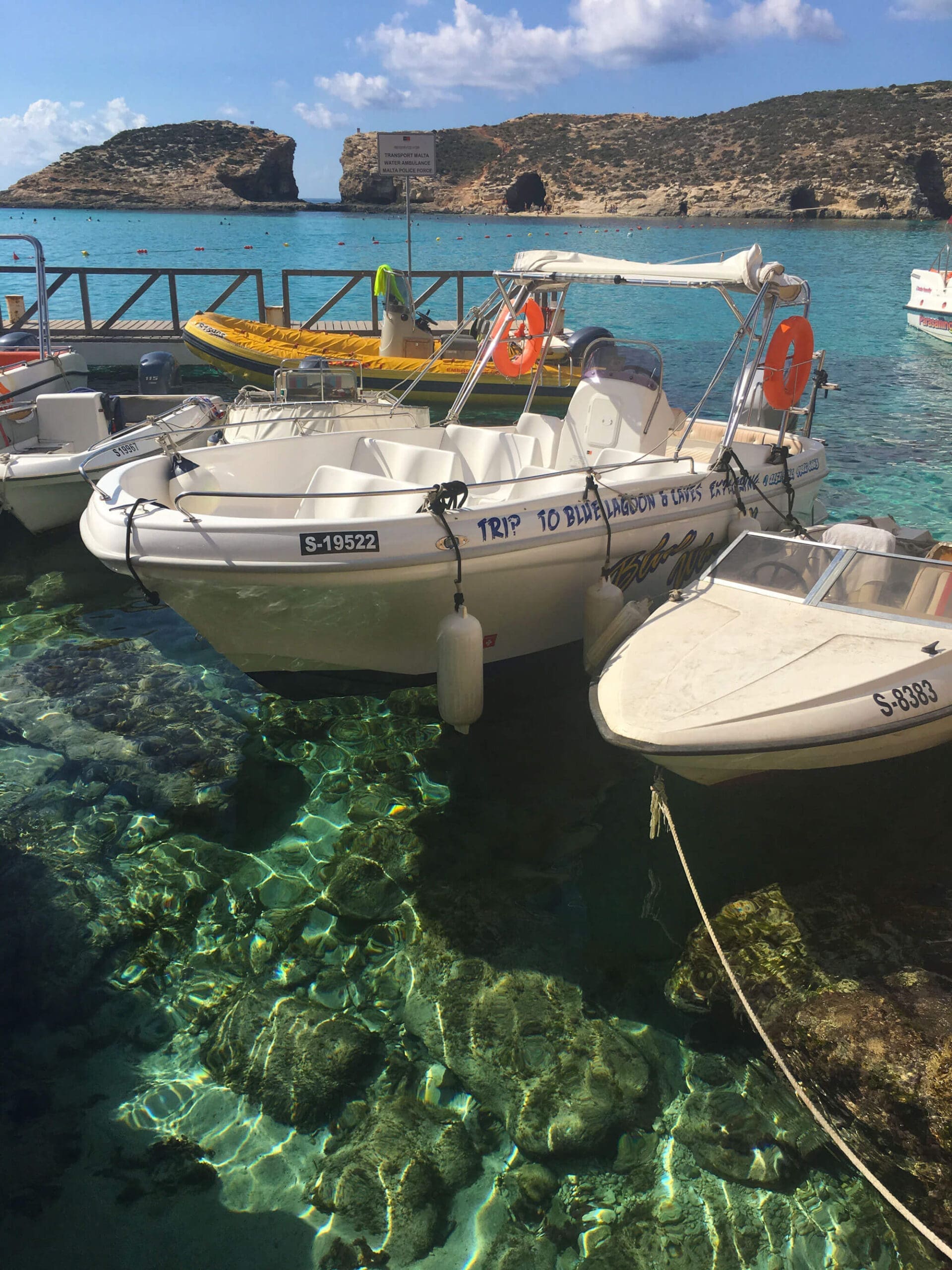 Boats docked over crystal clear blue water