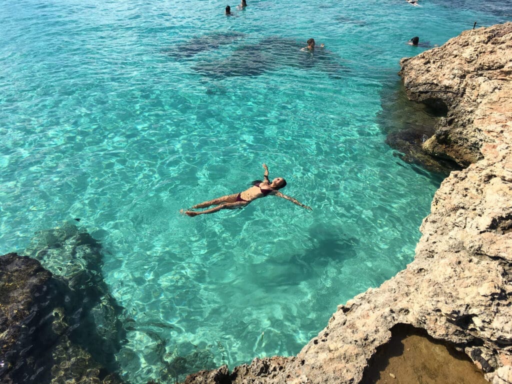 Girl floating in crystla clear blue waters