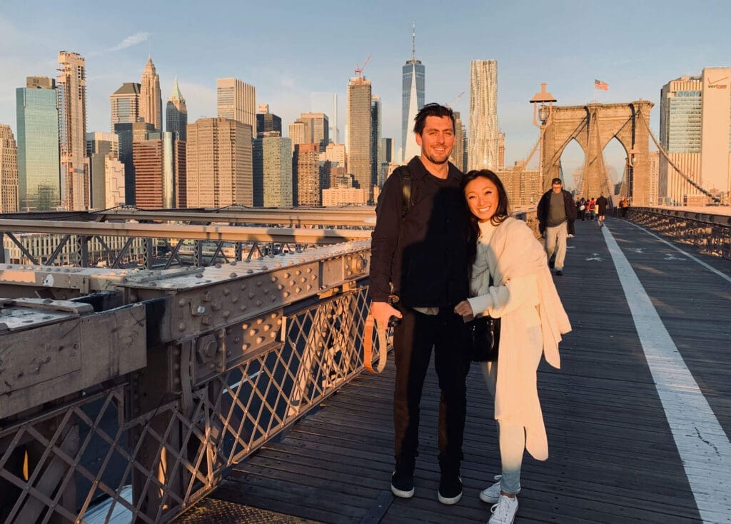 Couple on Brooklyn Bridge during sunries