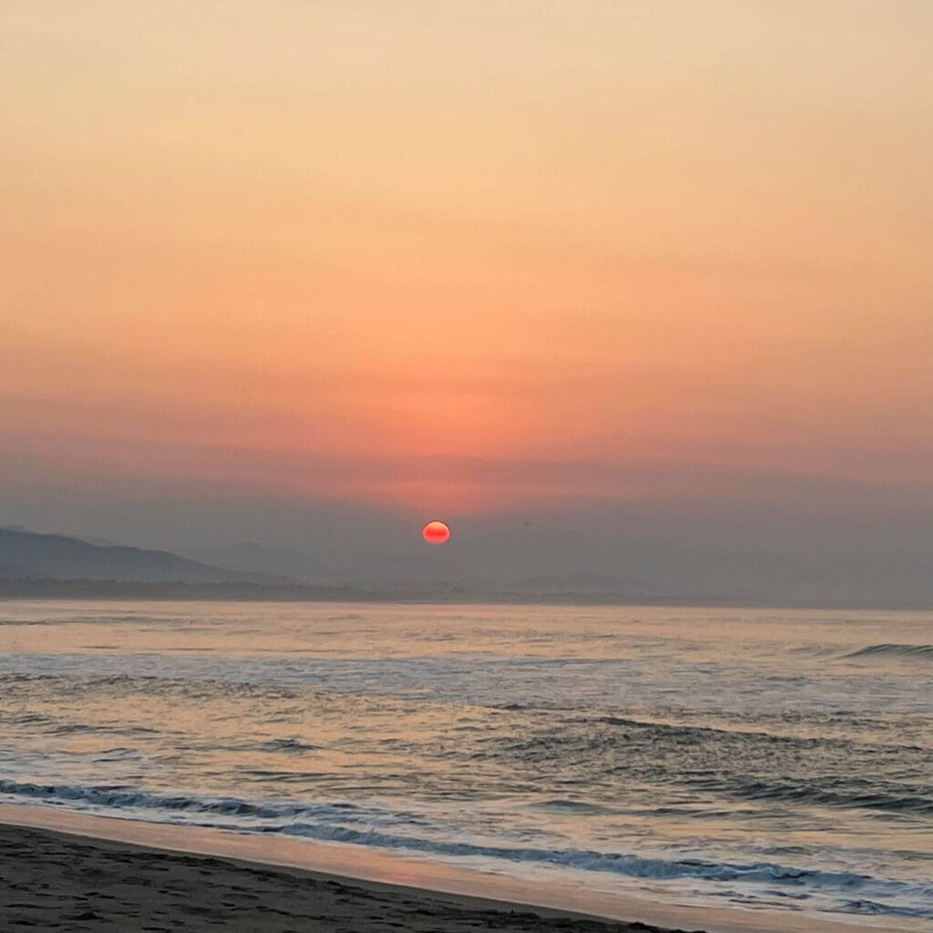 Orange sunset over the water in Chacahua