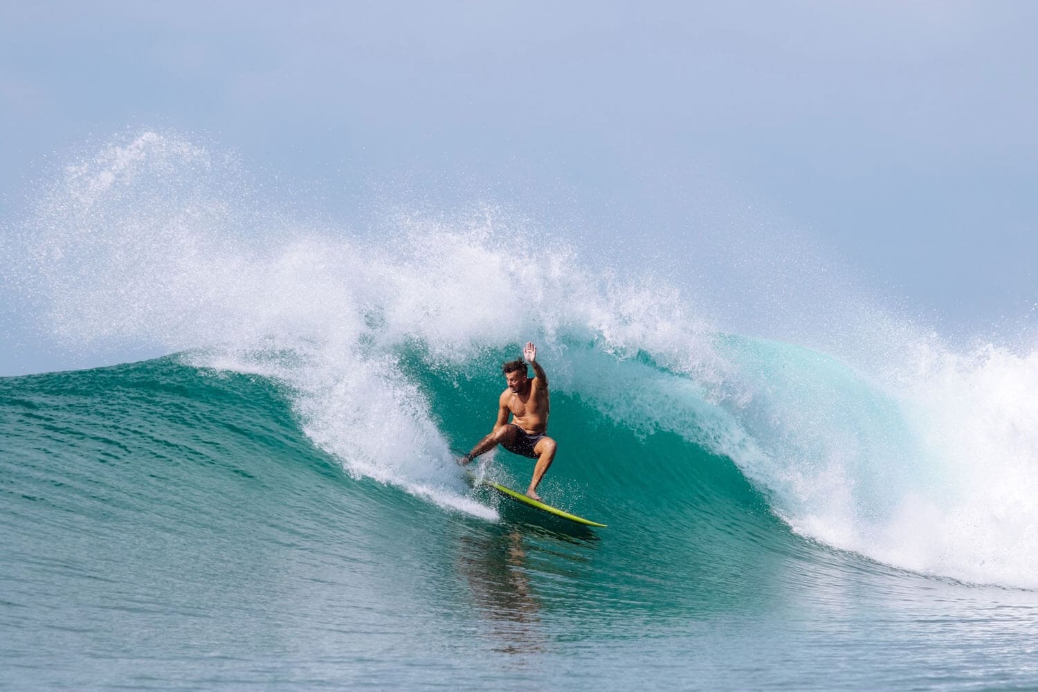 Man doing a cutback surfing in Nias