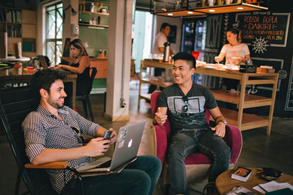 Two men socializing at a coworking hostel