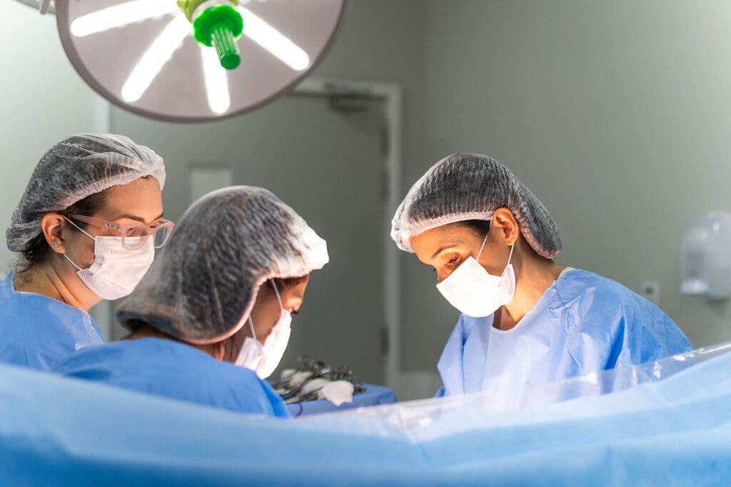 Three doctors in surgery room